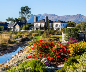 Upscale suburban home with garden, flowers, and mountain views.