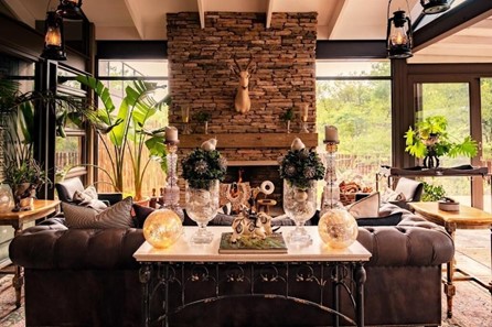 Cozy living room with stone fireplace and rustic decor.