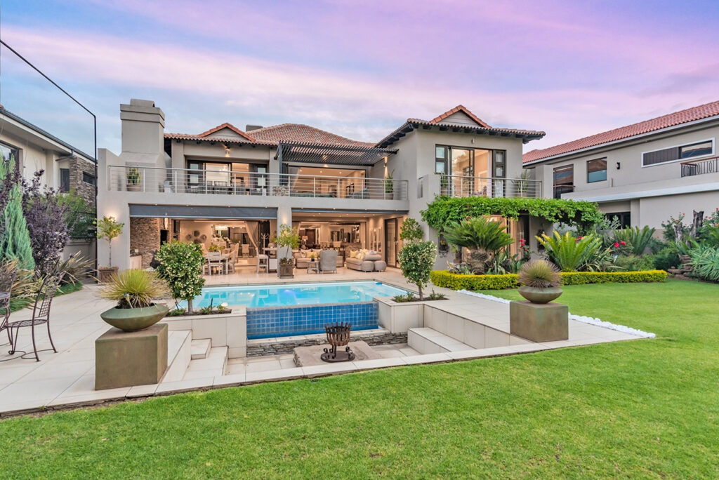 Pecanwood - R11.66m for a magnificent 4-bed home with extras, expansive patio, rim-flow pool, sunken fire pit, and views of the 18th fairway and Magaliesberg mountains.