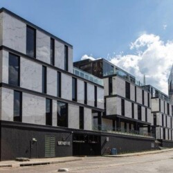 The white marble looking walls and strong undulating geometric design of 52 Katherine Street contrasts strongly against the dark organic slate.